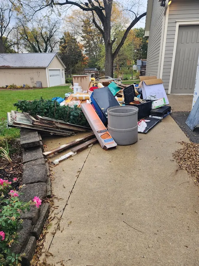 Dumpster being loaded with debris for Estate Cleanout Dumpster Rental in New Kensington